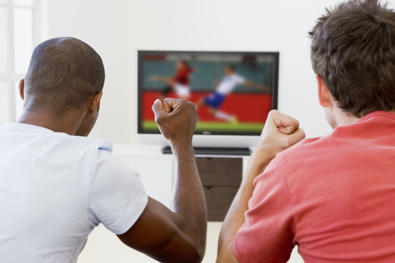 2139767-two-men-in-living-room-watching-television-and-cheering